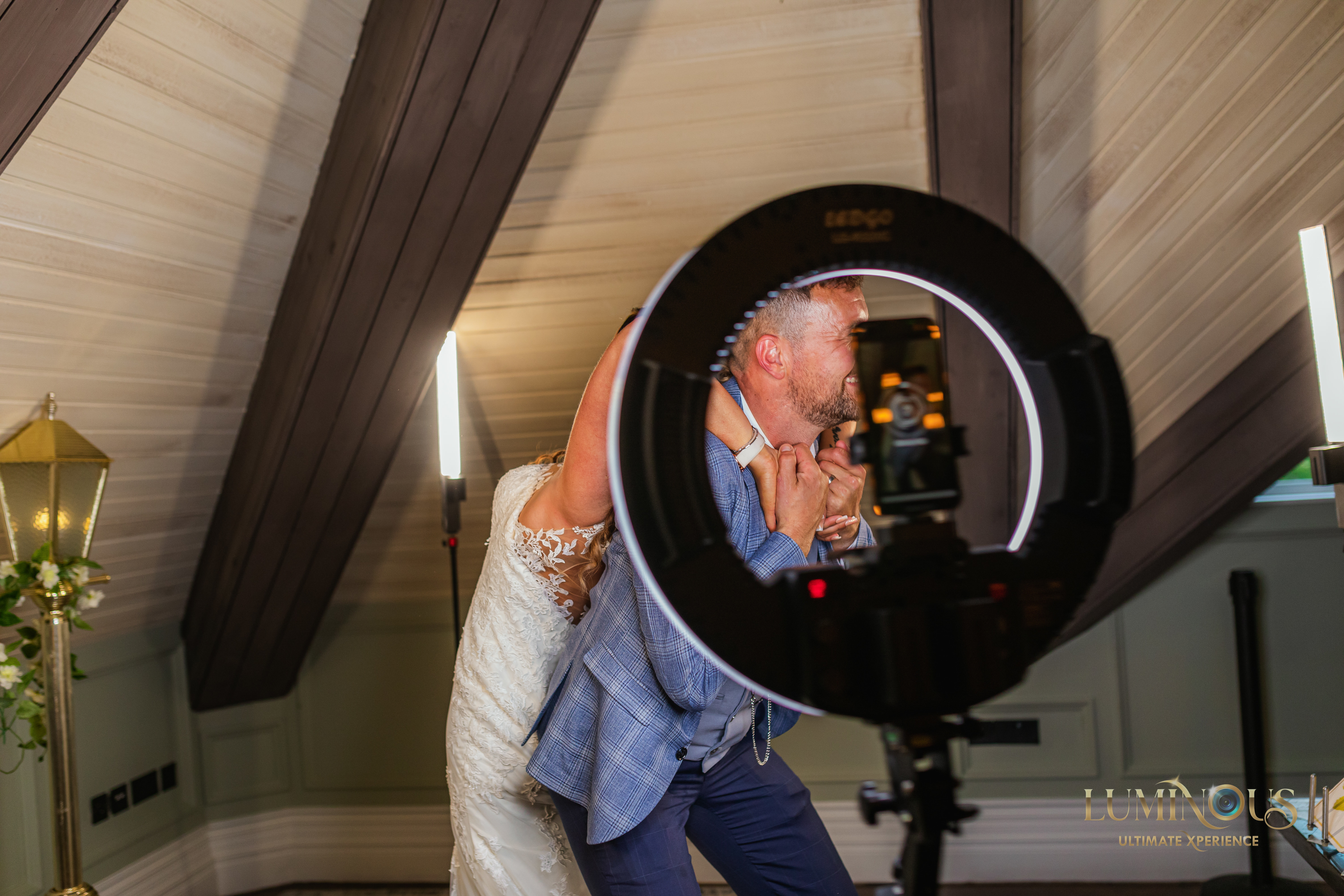 A couple at a wedding, party or prom having fun posing for photos on the 360