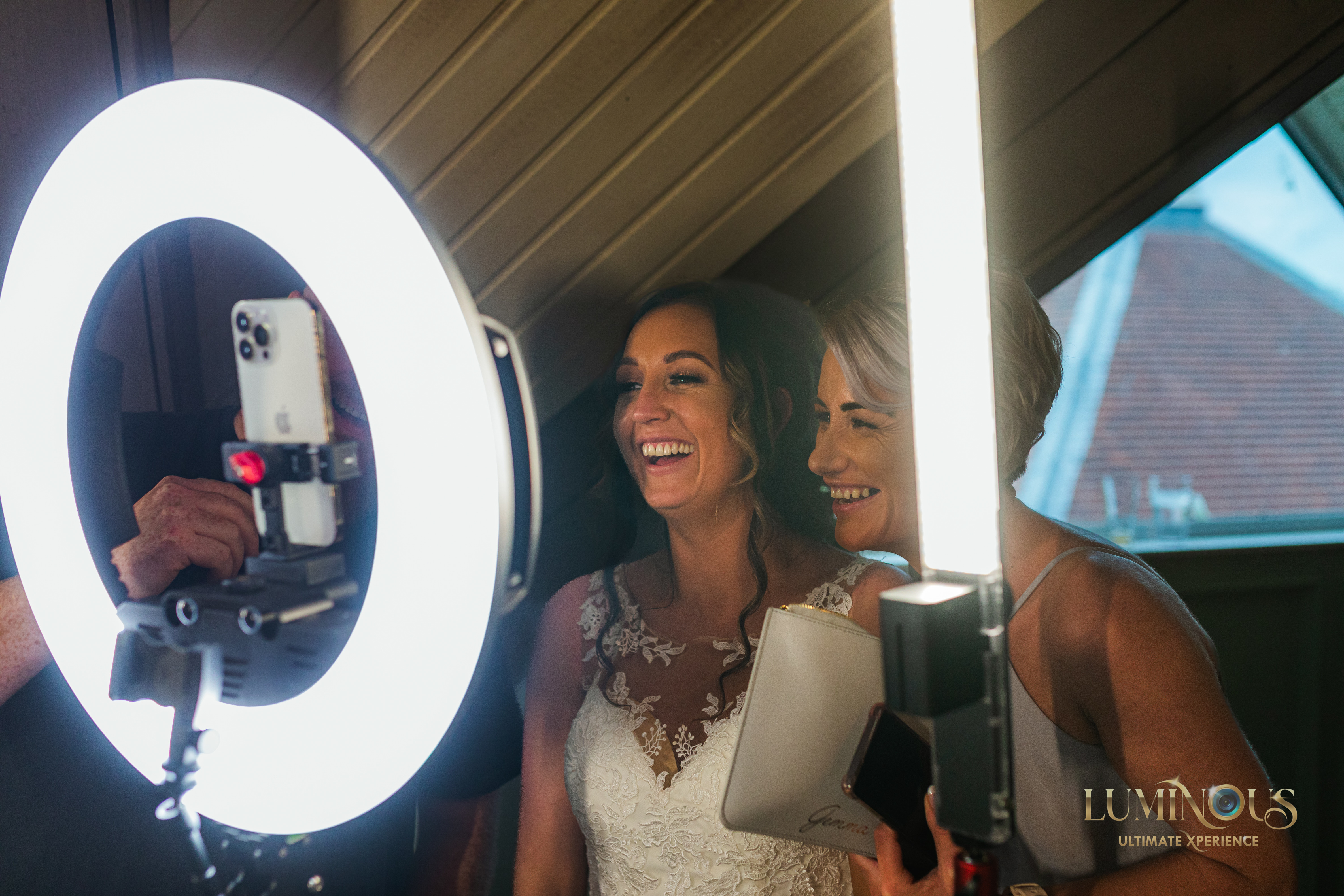 A couple of ladies at a wedding or party having fun posing for photos on the 360