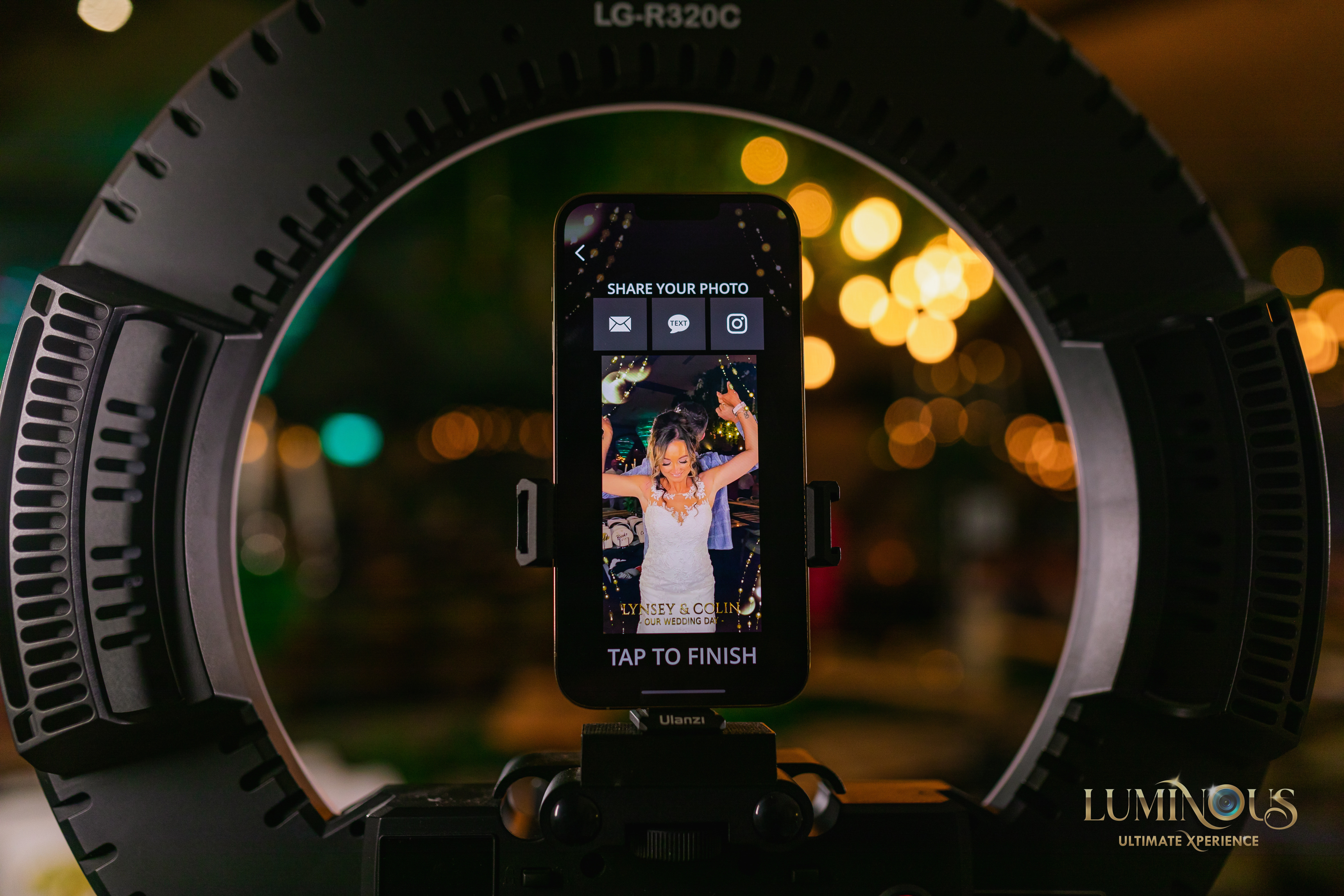 The 360 experience start screen waiting to tap to finish photos, taken of a couple at a wedding or party