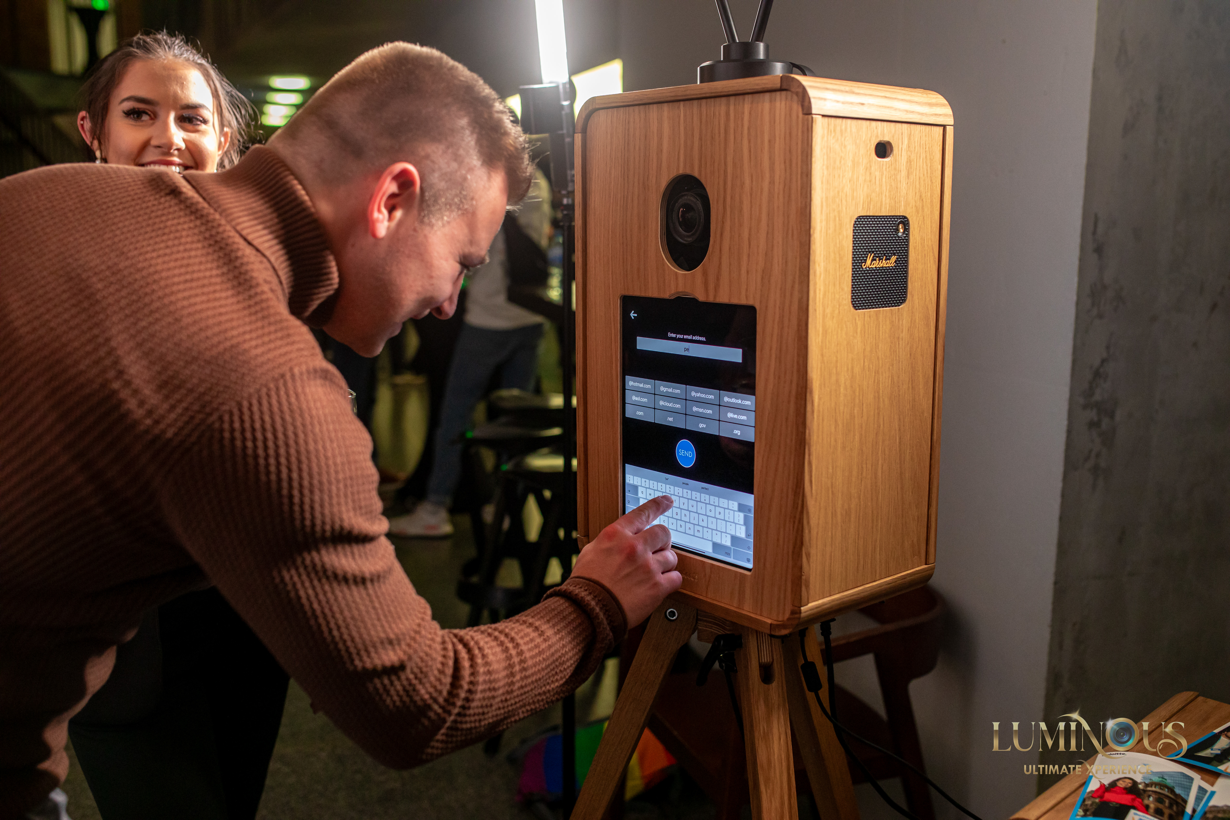 A guy typing his email address into the Everybooth to receive a copy of his photos